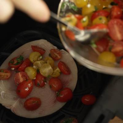 add cherry tomatoes to the fillet fish in the air fryer